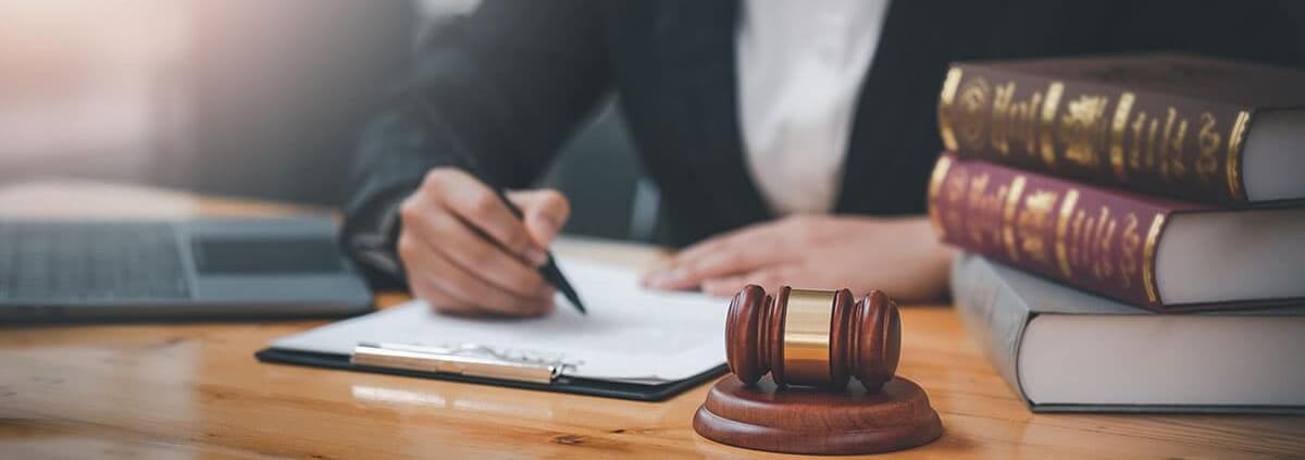 Attorney at desk, gavel, and books | The TGQ Law Firm
