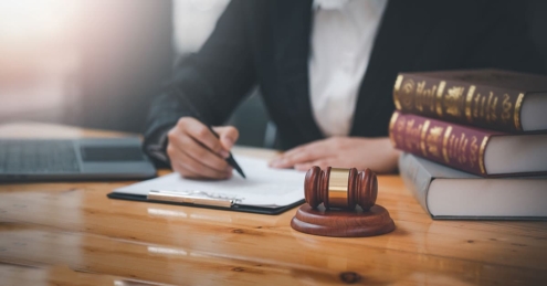 Attorney at desk, gavel, and books | The TGQ Law Firm
