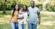 Happy Family Photo With Grass and Trees in the Background | Blended Family Estate Planning | The TGQ Law Firm