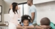 Two Children With Their Heads On A Table Upset With A Woman Arguing With Their Husband In The Background | Avoid The Step Mama Drama | Estate Planning For Stepfamilies | The TGQ Law Firm