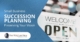 A Welcome We Are Open Please Come In Sign Hanging From A Small Business Window | Small Business Succession Planning | The TGQ Law Firm