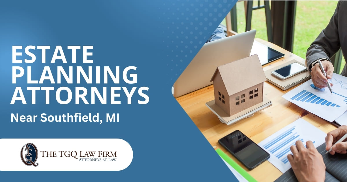 An Attorney Sitting With Clients at a Table With Paper Showing Graphs and Charts on Them With Notepads, Cellphone, Laptop, and a Model Home Also On The Table | Estate Planning Attorney Near Southfield, MI | The TGQ Law Firm